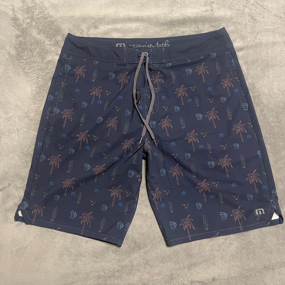 Travis Mathew Blue Board Shorts with Tropical Print